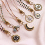 Gold and silver necklaces with moon and star charms on a pink background-3